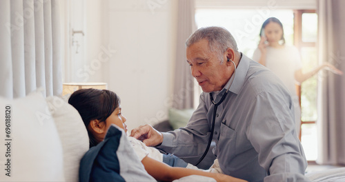 Senior, man and girl child with stethoscope in bedroom of home for healthcare, wellness and examination. Elderly, doctor and kid for pediatrician, patient and sick on bed in house with consultation © Wesley JvR/peopleimages.com