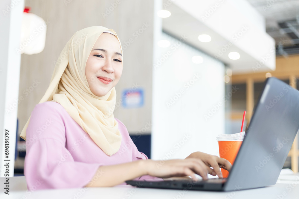 Cheerful Asian Muslim woman doing various poses in the free space and white background Cheerful Asian Muslim woman doing various poses in the free space and white background