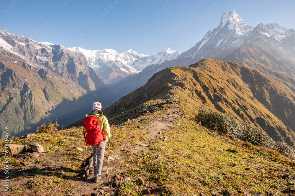 Rear view of female tourist looking to Mt.Machapuchare on Mardi Himal viewpoint, Nepal.
