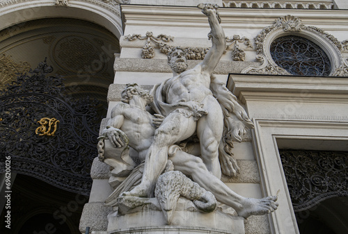Baroque statues on the entrance gate of St. Michael's Wing of Hofburg Palace on Michaelerplatz in Vienna, Austria photo
