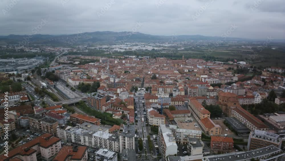 Slow aerial hyperlapse timelapse of the main street with traffic flowing in the town of Alba in northern Italy. Slow aerial hyperlapse timelapse of the main street with traffic flowing in the town of Alba in northern Italy.