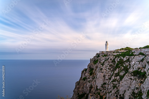 Dramatic Long Exposure of Lighthouse Atop Cliff Overlooking Silky Ocean