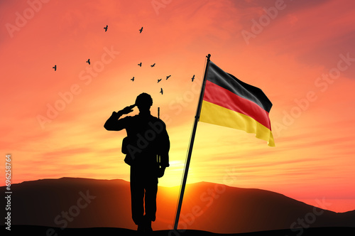 Silhouette of a soldier with the Germany flag stands against the background of a sunset or sunrise. Concept of national holidays. Commemoration Day. ©  minionionniloy
