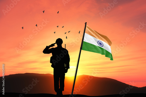 Silhouette of a soldier with the India flag stands against the background of a sunset or sunrise. Concept of national holidays. Commemoration Day. photo
