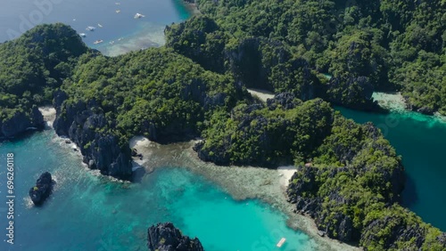 aerial drone shot of Indonesian islands with crystal clear water and green trees photo