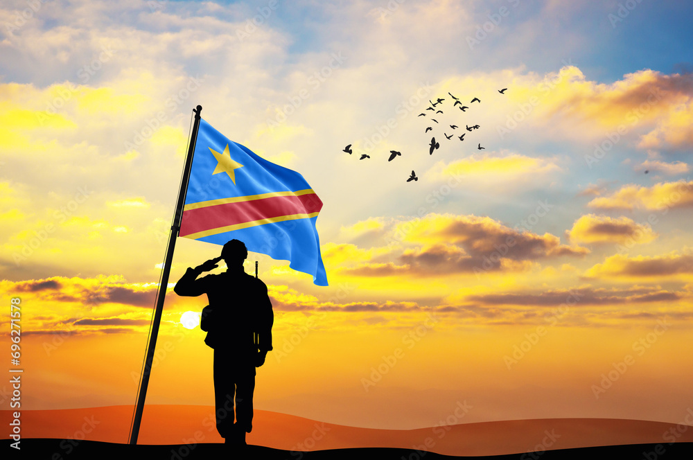 Silhouette of a soldier with the DR Congo flag stands against the background of a sunset or sunrise. Concept of national holidays. Commemoration Day.