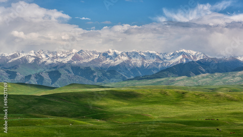 A picturesque plateau against the backdrop of snow-covered peaks in the Trans-Ili Alatau (Kazakhstan)