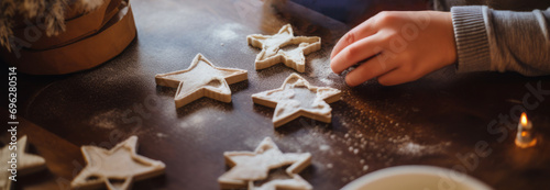 hand making Christmas cookies icing sugar wooden table festive atmosphere baking beakery