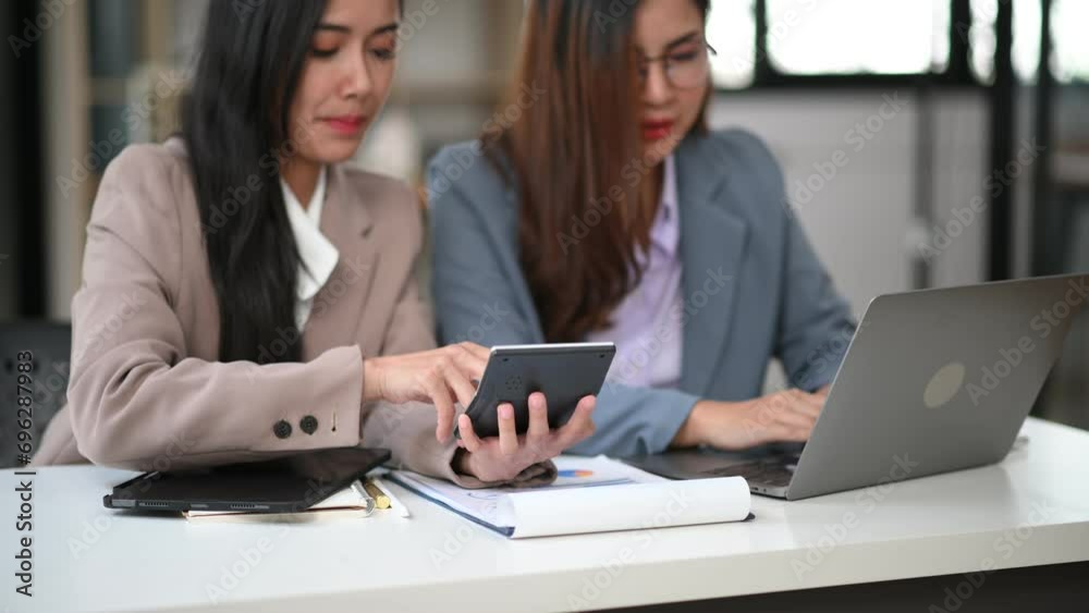 Asian business colleague business presents and explains and using laptop and tablet. Teamwork, financial marketing team Asian business colleague business presents and explains and using laptop and tablet. Teamwork, financial marketing team