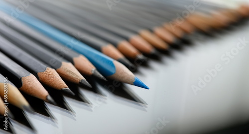 Blue pencil spy between black pencils segmentation closeup. Sexual minorities in society concept