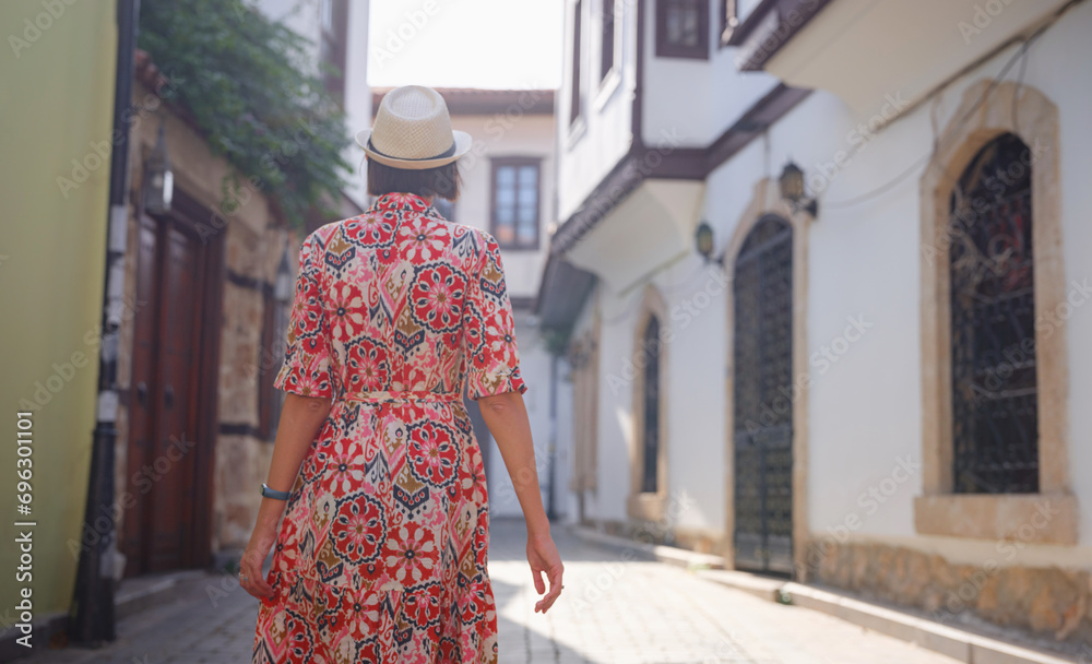 female summer travel to Antalya, Turkey. young asian woman in red dress walk through old town Kalechi , female tourist traveler discover interesting places and popular tourist attraction female summer travel to Antalya, Turkey. young asian woman in red dress walk through old town Kalechi , female tourist traveler discover interesting places and popular tourist attraction