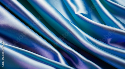 Turquoise purple satin fabric in large folds.