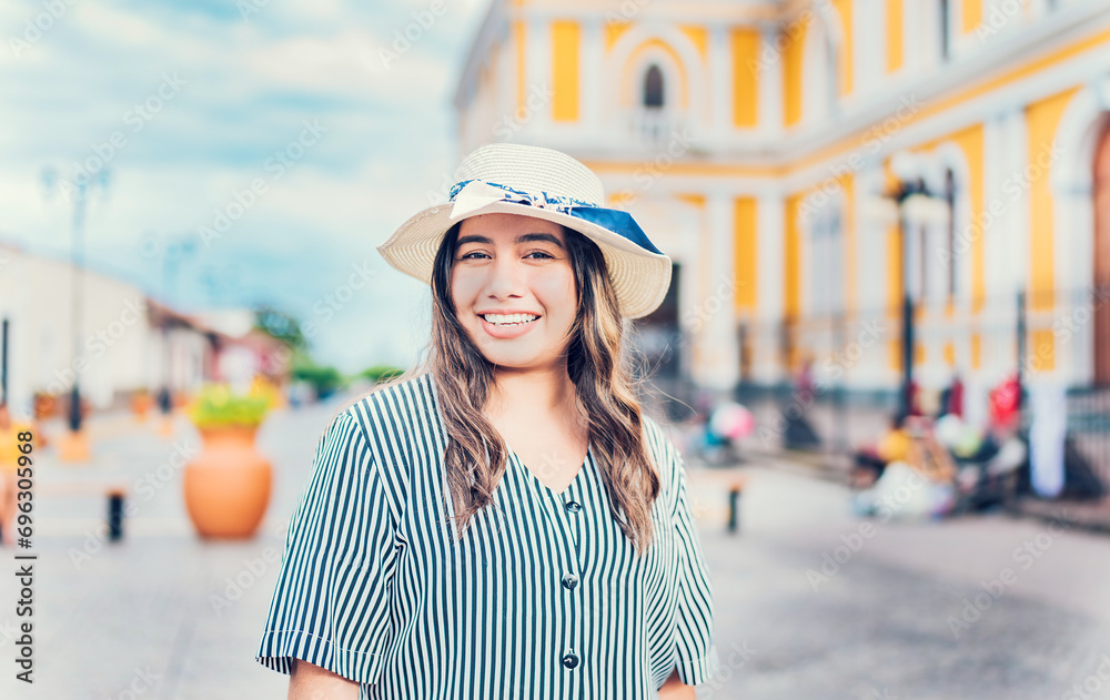 Lifestyle of happy traveler woman in a tourist square. Portrait of smiling tourist girl on the streets of Granada, Nicaragua Lifestyle of happy traveler woman in a tourist square. Portrait of smiling tourist girl on the streets of Granada, Nicaragua