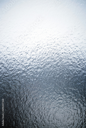 Freezing rain on a window, ice on the windowpane. Frost ice patterns on a window glass. Rime on a windowpane, Bitter cold. Frosted glass window. Ice Background photo