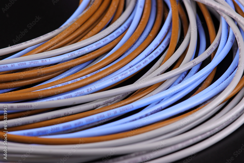 Electrical installation wires in colored insulation on a dark background. Close-up.
