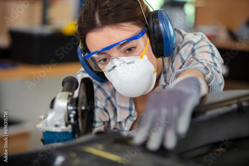 coachbuilding taining girl standing in garage photo