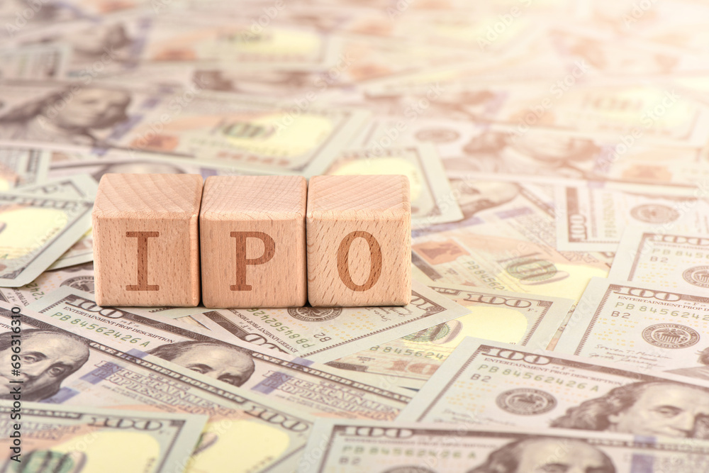 There are blocks with IPO letters printed on the US dollar props There are blocks with IPO letters printed on the US dollar props