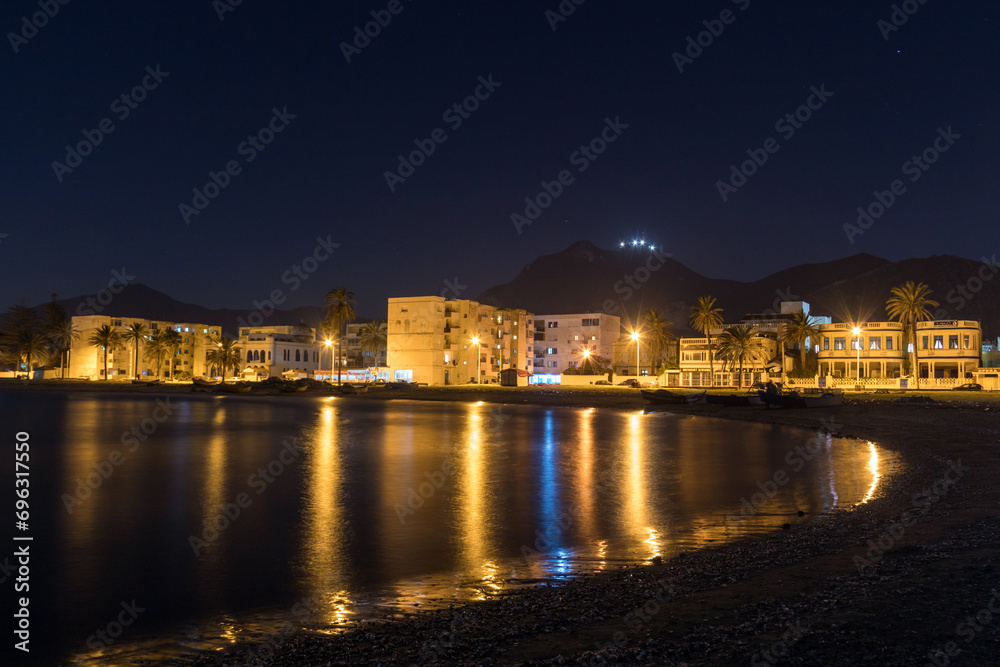A Night View of Houses and Street Lights by the Sea in Tunis.