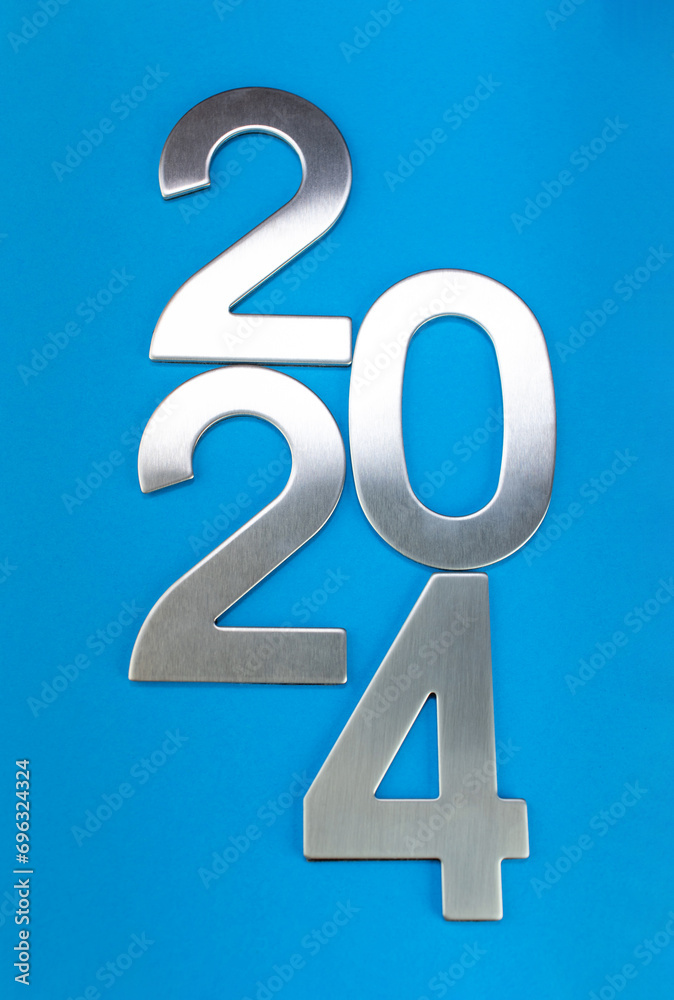Composition with the number 2024 made of silver on a blue monochrome background