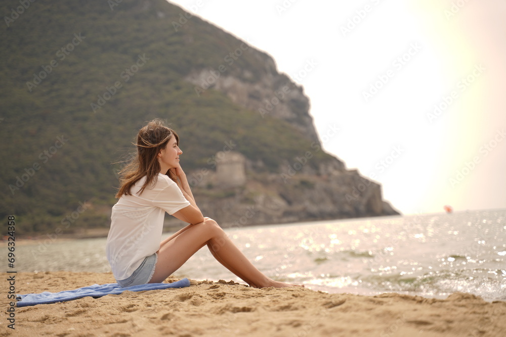 Unrecognizable woman on beach in cloudy day. Serenity, tranquility, solitude, reflection concept Unrecognizable woman on beach in cloudy day. Serenity, tranquility, solitude, reflection concept