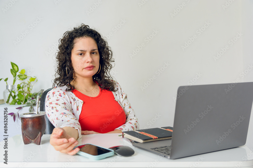 closeup of businesswoman sitting in her office talking looking at camera and gesturing with hands closeup of businesswoman sitting in her office talking looking at camera and gesturing with hands