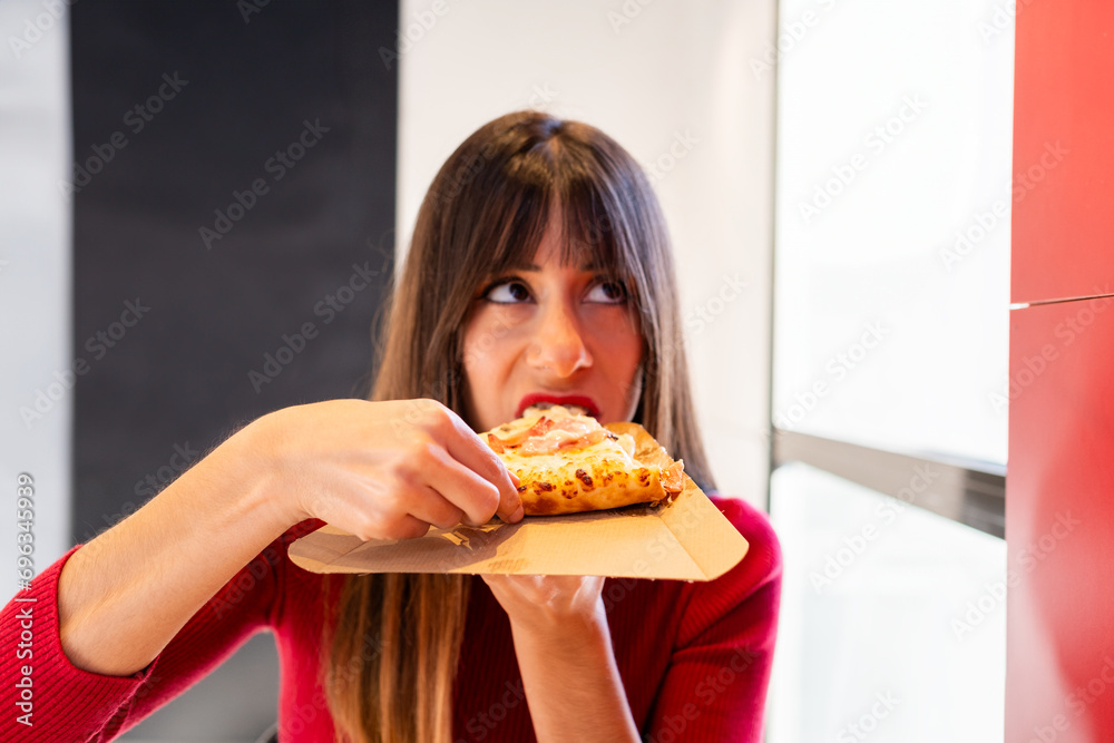 Brunette enjoys fast-food pizza bliss. Brunette enjoys fast-food pizza bliss.