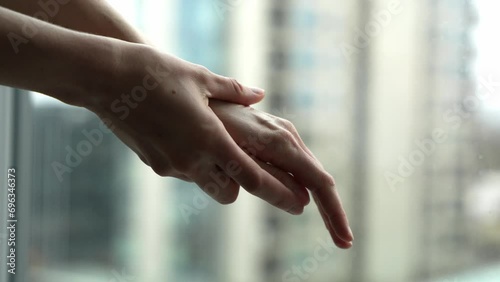 Close-up camera view of woman putting hand cream. Female gently applying cream to her hands. Beauty, health concept.