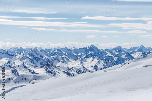 Snow-covered winter mountains of the Caucasus on a sunny day. Panoramic view from the ski slope of Elbrus, Kabardino-Balkaria, Russia © Viiviien