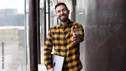 friendly adult man human resources worker looking at camera ready to shake hands welcoming new coworker - gesturing