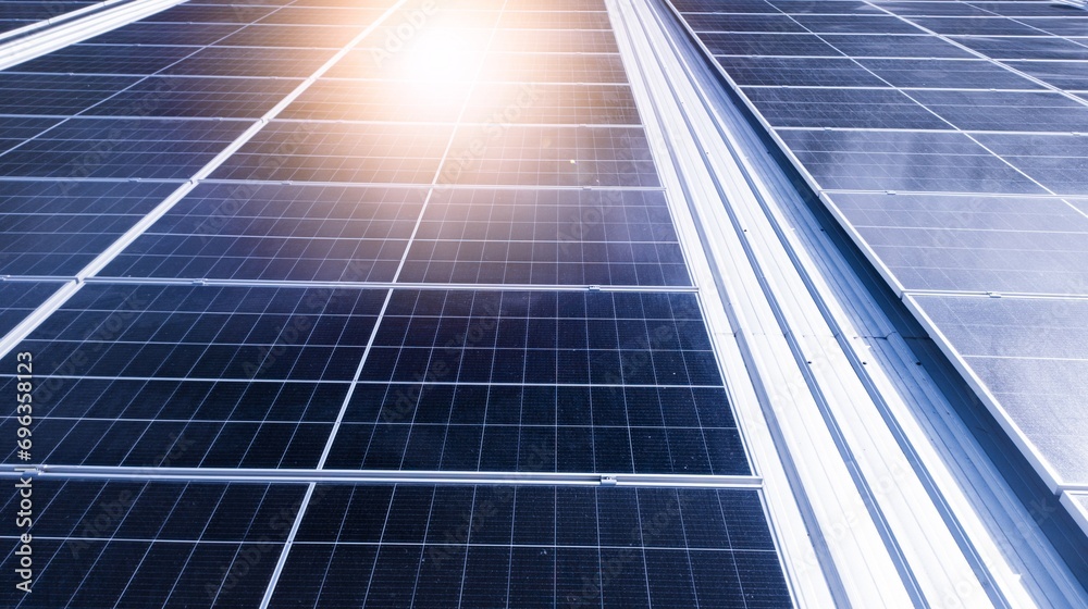 Fototapeta premium Photovoltaic solar panels mounted on building roof for producing clean ecological electricity at sunset.Photovoltaic panels on the roof.View of solar panels in the building,renewable energy concept