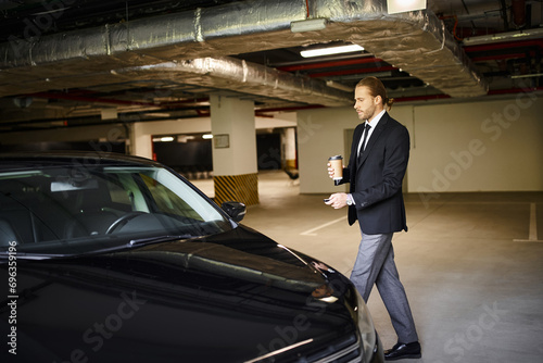 Wallpaper Mural attractive elegant man with beard in black suit holding coffee cup and car keys, business concept Torontodigital.ca