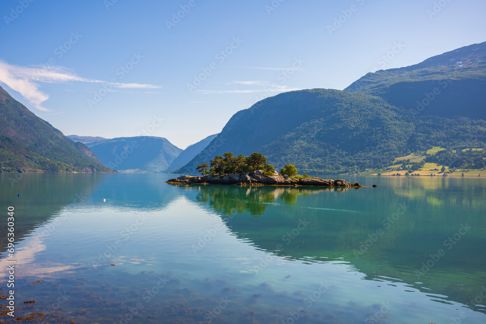 The view of the calm waters of Barsnesfjorden, the innermost part of the fjord arm Sogndalsfjorden near the Sogndal municipality from Krossen Rest Stop during a summer morning.