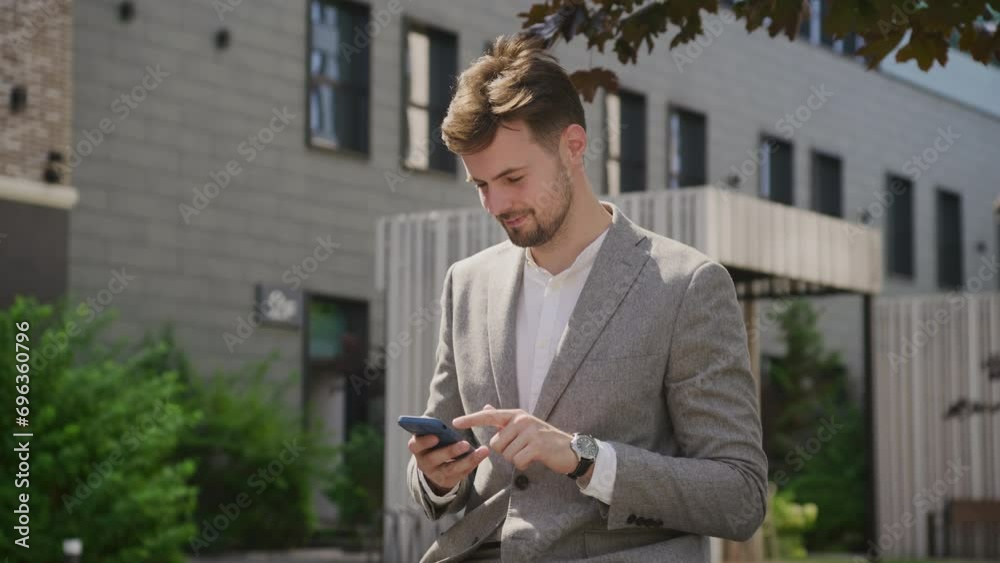 Businessman Checking Phone in City Garden Businessman Checking Phone in City Garden