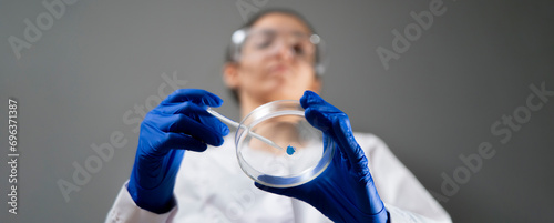 Cuadro en lienzo bottom view of scientist holding petri dish and examine the biological sample, h