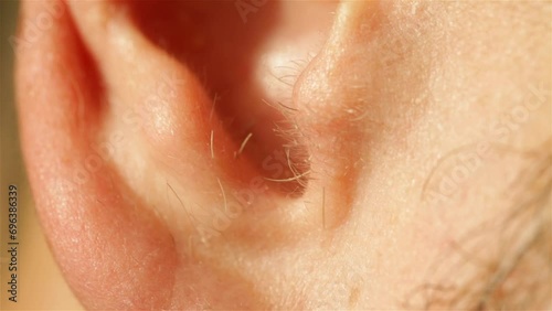 The ear of a man with hair is very close photo