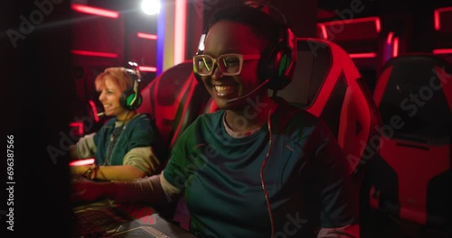 Young female gamers high fiving during tournament