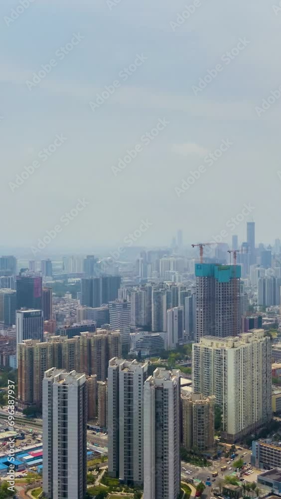 Shenzhen City at Sunny Day. Luohu and Futian District. Blue Sky. Residential Neighborhood. Guangdong, China. Aerial Time Lapse, Hyper Lapse. Drone Flies Sideways and Upwards. Vertical Video Shenzhen City at Sunny Day. Luohu and Futian District. Blue Sky. Residential Neighborhood. Guangdong, China. Aerial Time Lapse, Hyper Lapse. Drone Flies Sideways and Upwards. Vertical Video