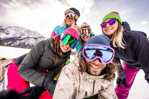 Tableau sur toile Group of snowboarders on winter holiday season having fun and bonding outdoors i