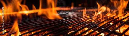 Empty flaming grill grates with open fire, ready for product placement. Background for grilled food with fire.