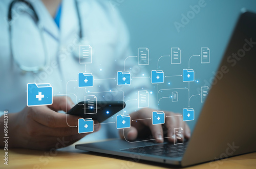 A medical worker works with an electronic database and documents.Technology and access information, database, storage, Digital link tech, big data photo