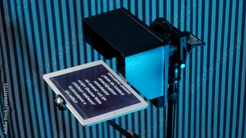 teleprompter for video. The reading text is reflected from the glass surface opposite the video camera lens