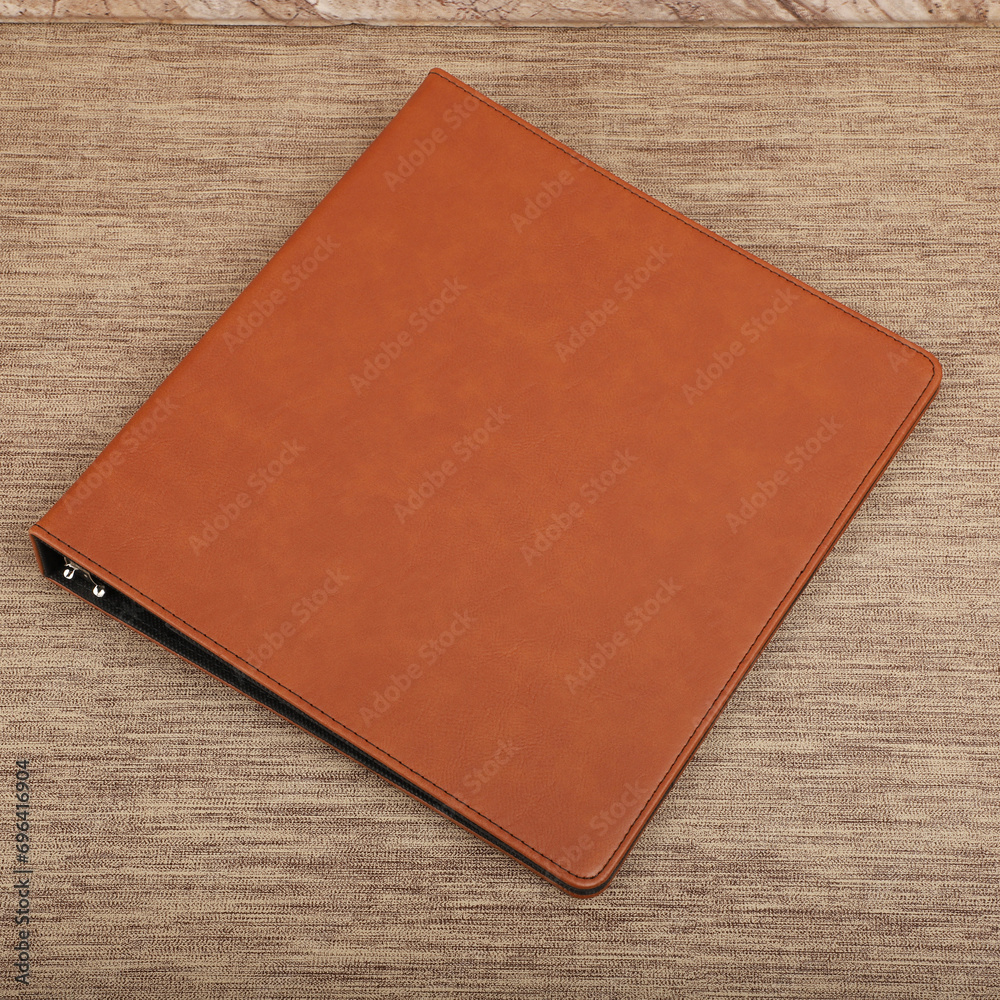 Fototapeta premium Personalized binding, leather folder cover, leather binding, binder, binder, office binding, corporate gift. Concept shot leather binding, top view, colorful