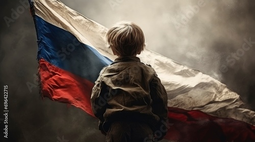 Little boy looking at Russian flag. Russian National Day. Russian Child photo
