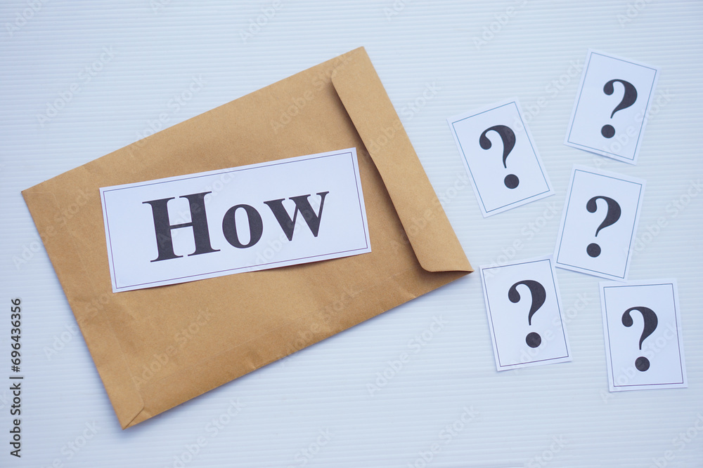 Word cards with question word How on brown envelope and cards of