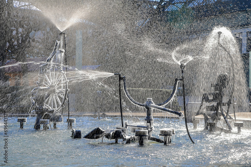 Obraz na płótnie The Tinguely fountain in the city center Basel with partly frozen parts and splashing in backlit in cold winter weather w salonie