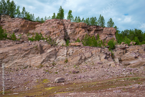 In an abandoned quarry for the extraction of raspberry quartzite. Karelia, Russia photo