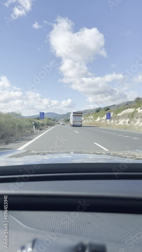 First person view, FPV, from dashcam of car driving on highway from Valencia towards Murcia, Andalusia, Spain, Europe. Road trip video in POV, vertical video photo