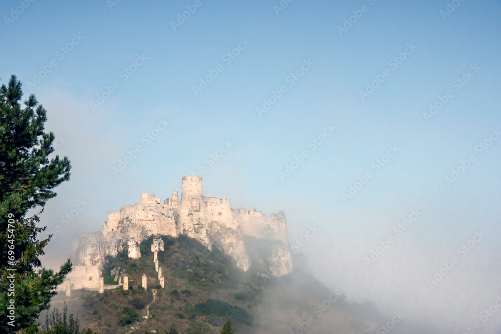 Spis castle emerging from the fog