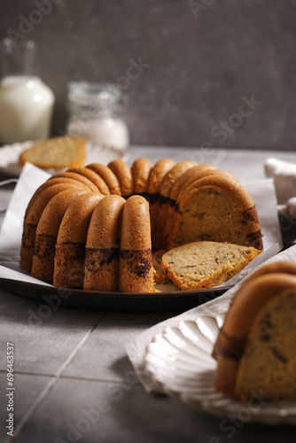 homemade marble cake on a rustic plate with rustic grey tiles background (ID: 696463537)
