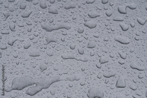 Creative background. Raindrops on a gray car